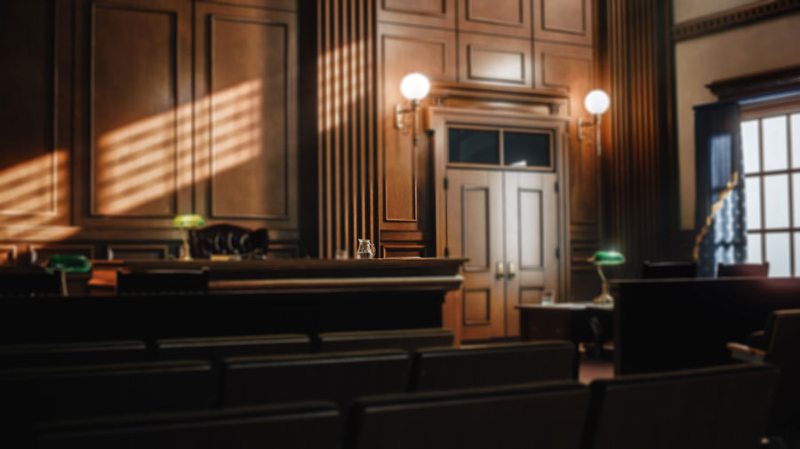 Background image for Tim Rayne Kennett Square Car Accident Lawyer featuring a courtroom beneath a blue filter.